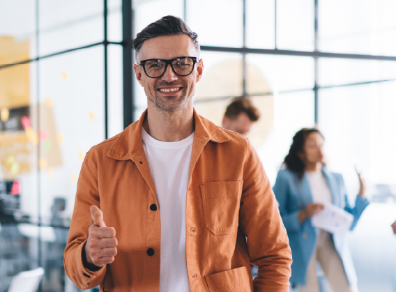 Cheerful man with coworkers in office