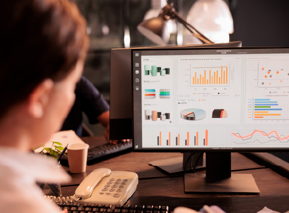 Woman reading corporate marketing report on computer screen